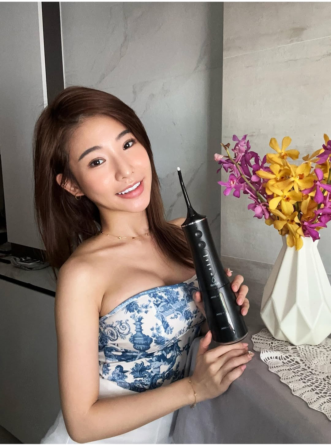 Influencer using Feel Fresh AquaJet+ Water Flosser for daily home oral care routine