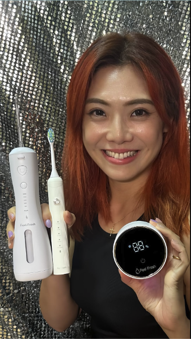 Woman holding a white electric toothbrush and a digital timer against a sparkling background